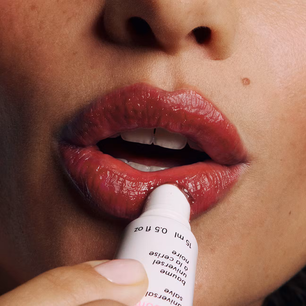 Lip product being applied to red lips